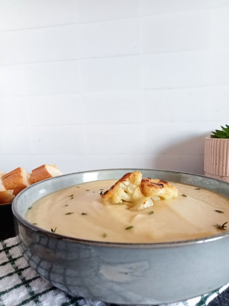 Cauliflower soup made with only 3 main ingredients in a bowl garnished with cauliflower florets.