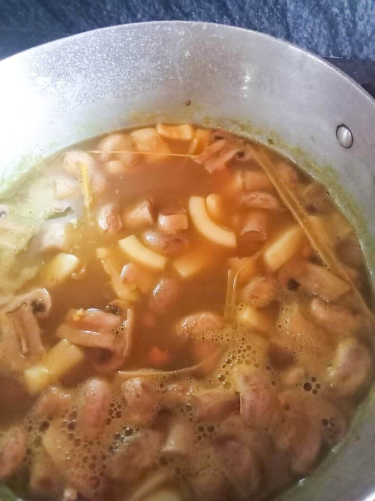 Process photo mixed seafood added to a pot while cooking Tom Yum Soup