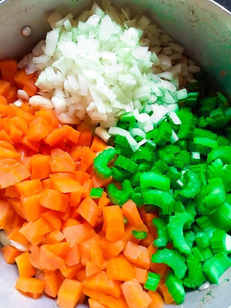 chopped carrots, onion, celery on top of white beans.