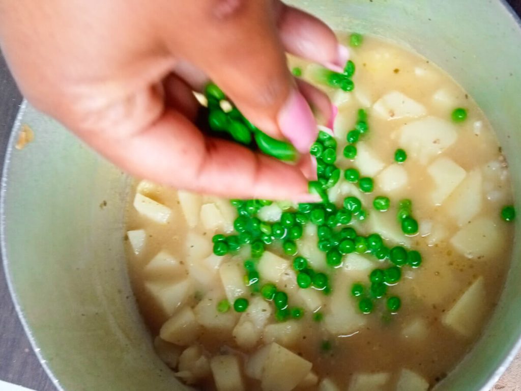 Process photo- adding green peas to the soup.