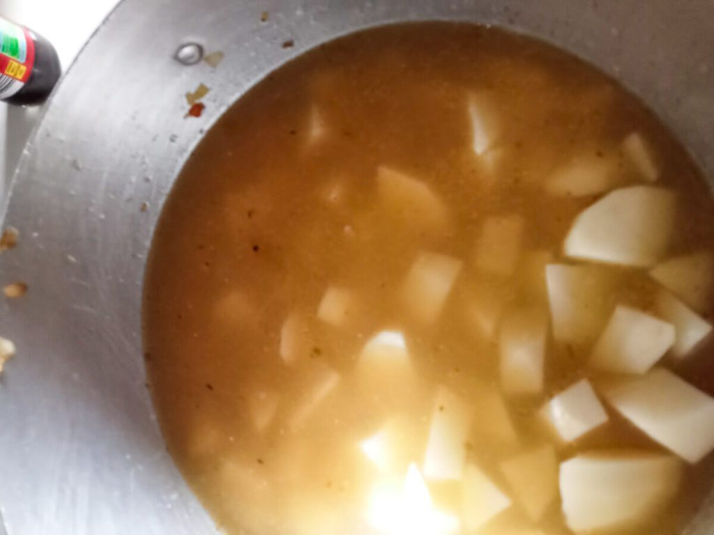 Process photo- boiling potatoes with broth.