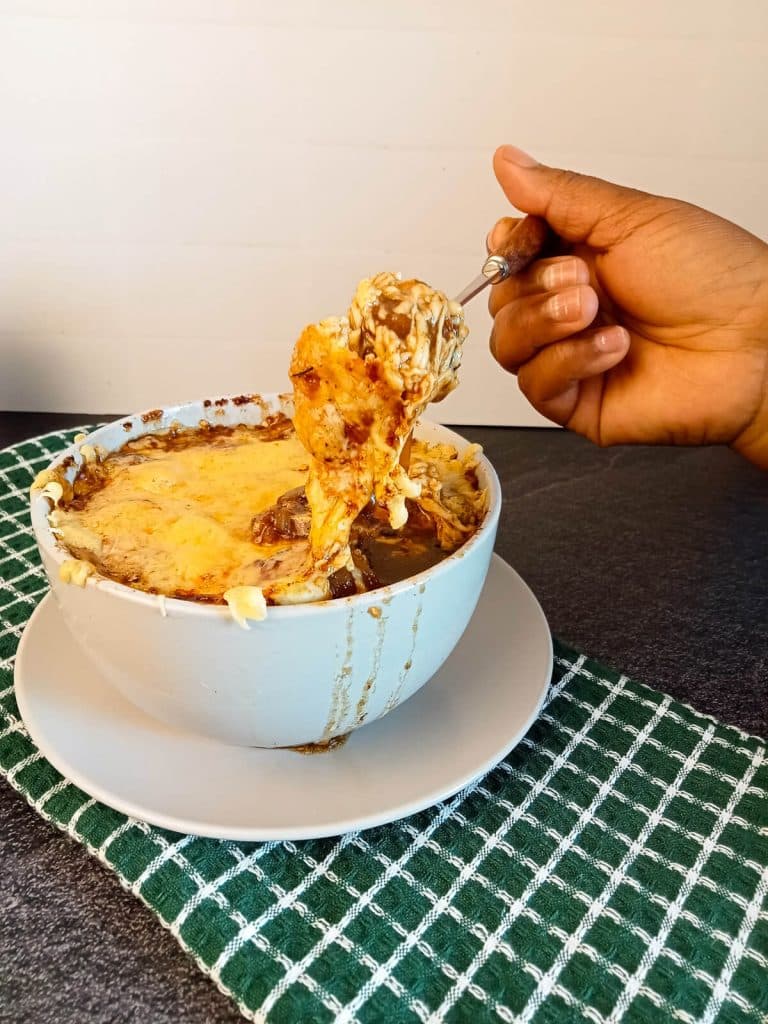 Pulled cheese image of Roy Choi French onion soup.