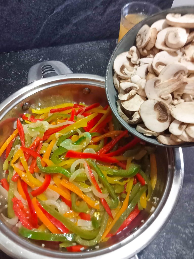 process photo- adding mushrooms to the pot.