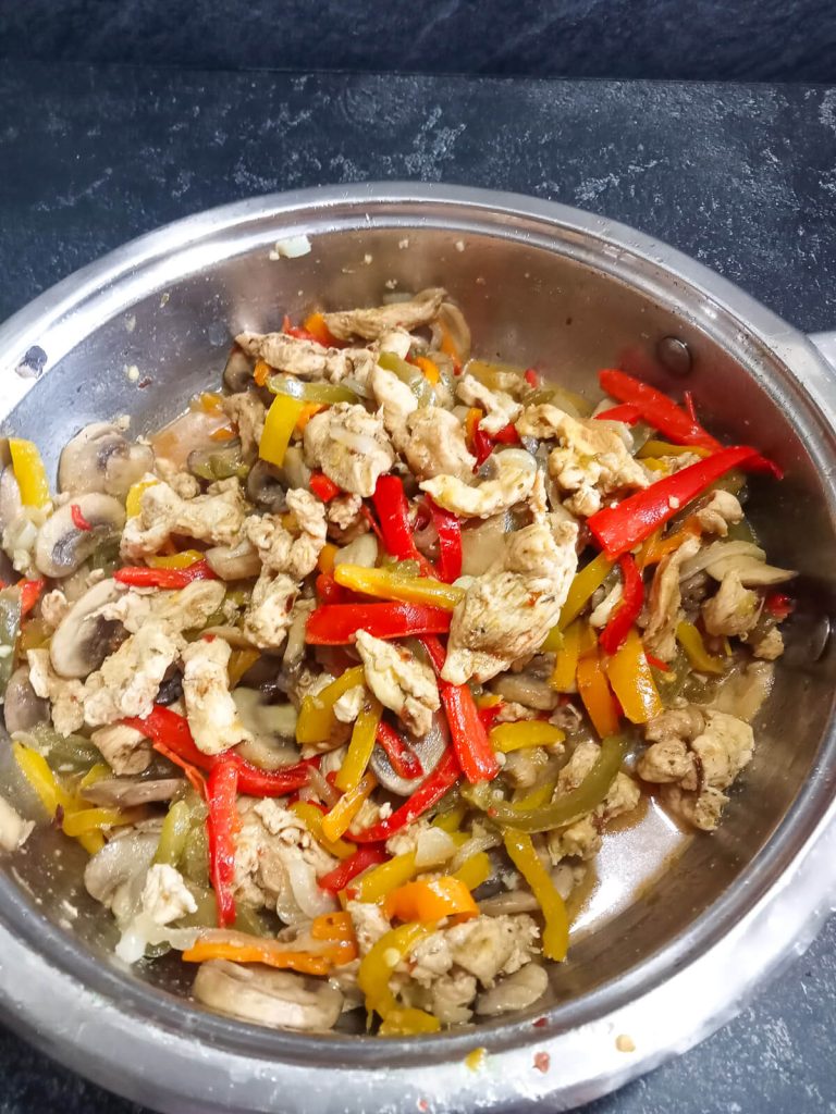 chicken stir fry in a pan.