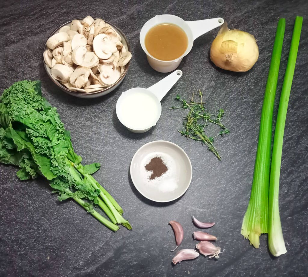 Ingredients photo consisting of mushrooms, kale, garlic, celery, onion, vegetable broth, cream, black pepper, and thyme.