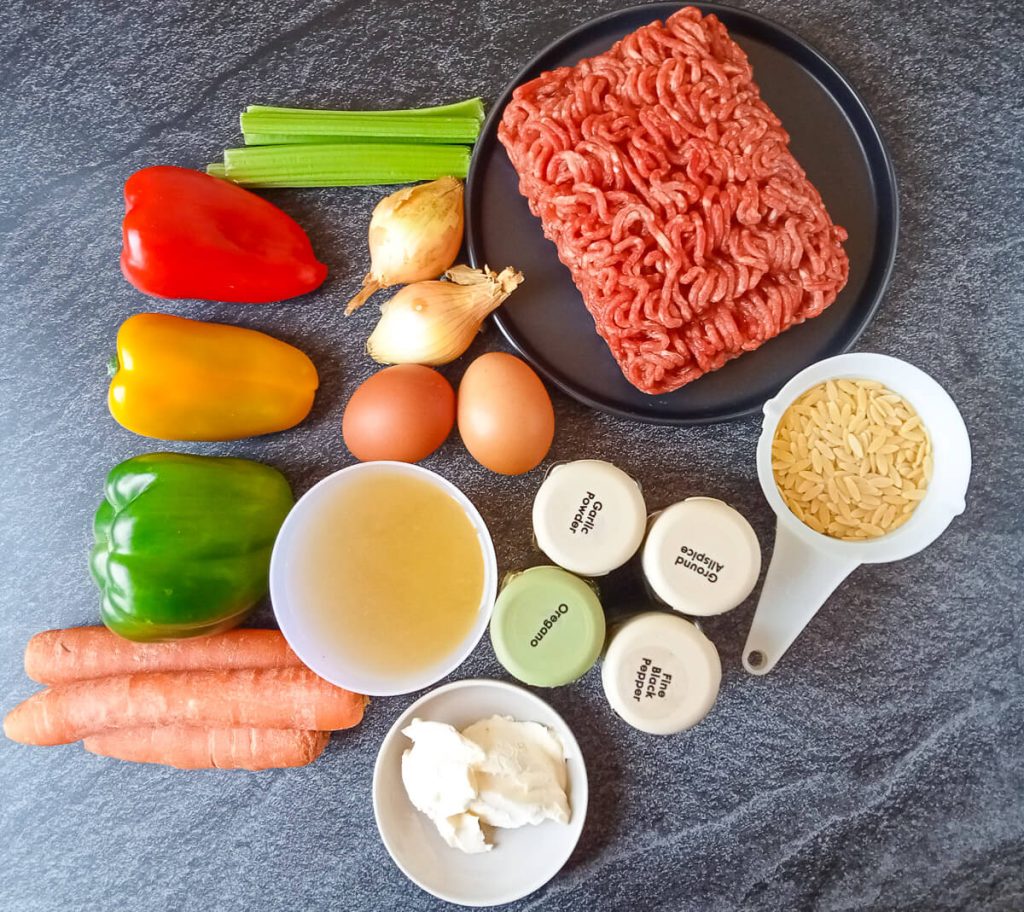 Ingredients photo: in the image, there is bell peppers, carrots, celery, onions, eggs, beef stock, cream, orzo pasta in a cup and seasoning spices.