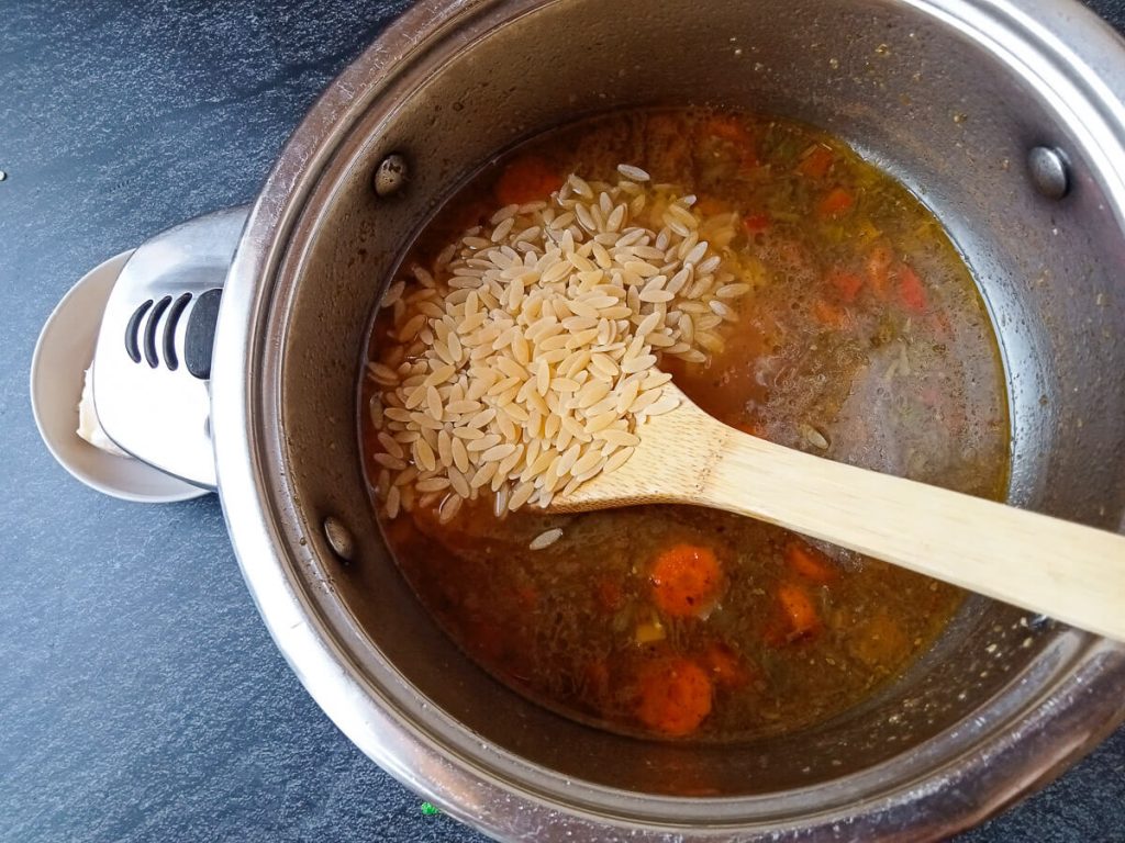 process photo: adding uncooked orzo pasta into the pot.