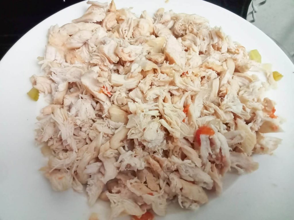 shredded chicken on a white plate.