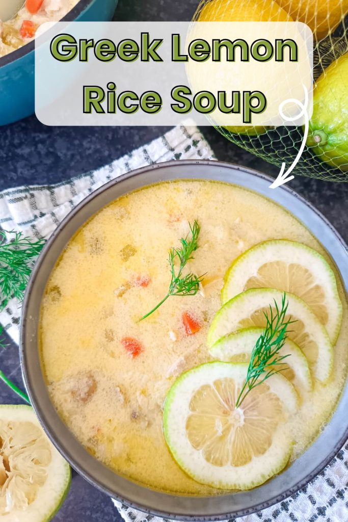 An image was a bowl of Greek lemon rice soup with a black background and the bowl is on top of a green and white tablecloth. Beside the bowl, there is a pot of the soup and some used lemons as well as fresh herbs.