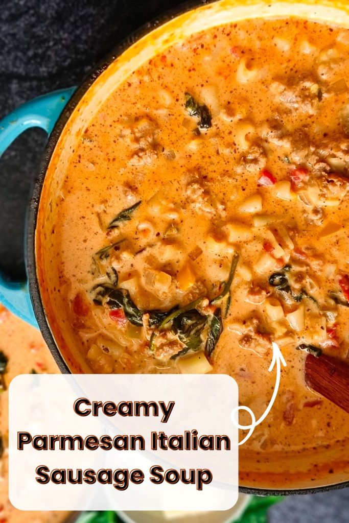 An image of a chicken parmesan soup in a cast-iron pot with a serving bowl next to it and other leftover ingredients, all on a black background.